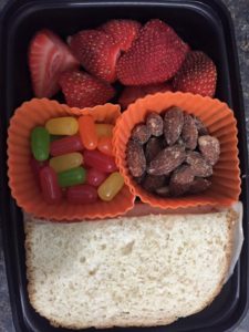 Boarshead lunch meat on homemade bread Sliced strawberries Hickory Smoked Almonds Candy